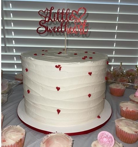 Little Sweetheart cake with white frosting and pink-lined cupcakes from Sweet B's Bakery