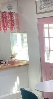 Pink interior door and hanging flowers at Sweet B's Bakery